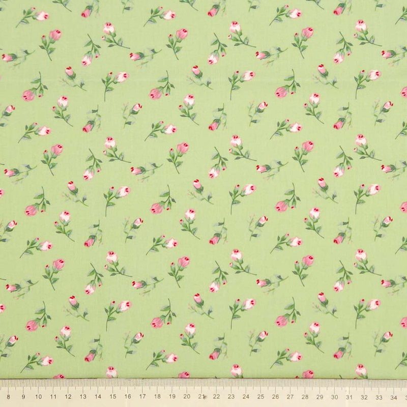 Floral pattern with pink flowers and green leaves on a sage green cotton poplin with a cm ruler