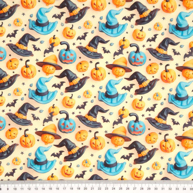 Halloween-themed fabric pattern with pumpkins, witch hats, and bats on a beige cotton fabric