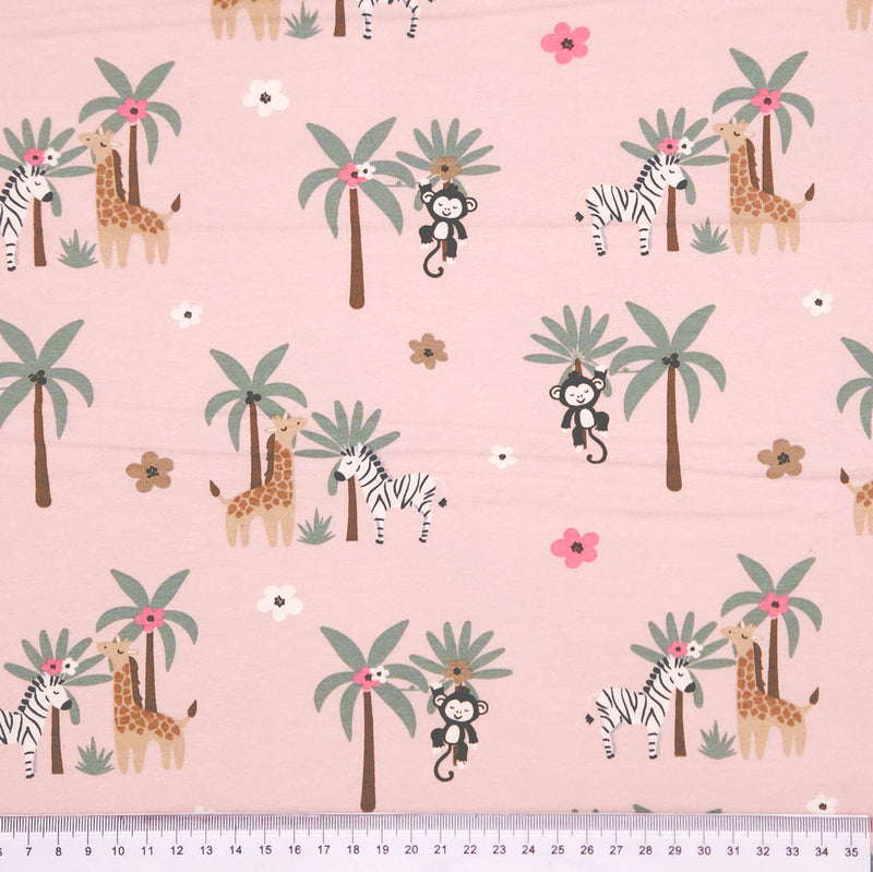 Monkeys and zebras printed on a pink cotton jersey fabric with a cm ruler