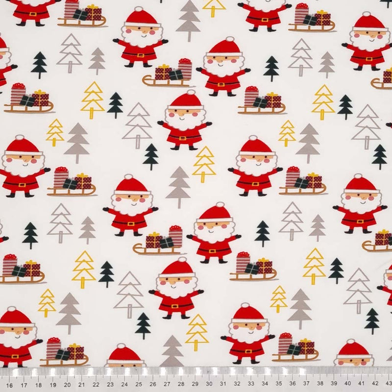 Santa and sleigh is printed on an ecru cotton jersey fabric with a cm ruler