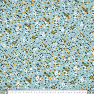 Floral pattern with small flowers on a duck egg viscose fabric with a ruler