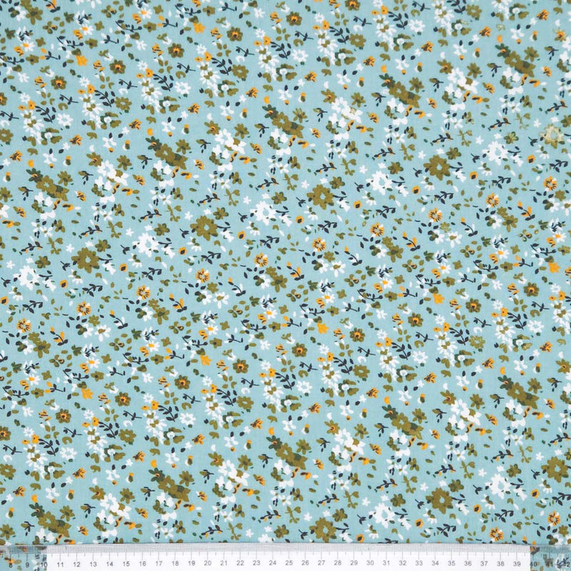 Floral pattern with small flowers on a duck egg viscose fabric with a ruler