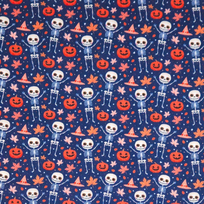 Pattern of skeletons, pumpkins, and leaves on an indigo halloween polycotton fabric