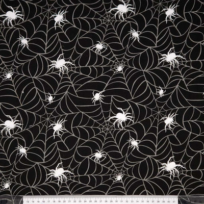 Black fabric with white spider webs and spiders pattern