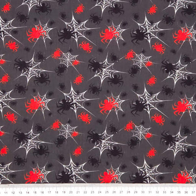 Halloween-themed fabric with spiders and webs on a gray halloween polycotton fabric.