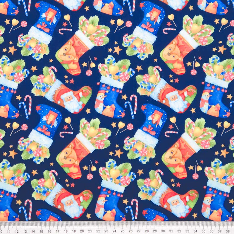 Pattern of Christmas stockings with Santa Claus on a blue background, with a ruler at the bottom for scale.