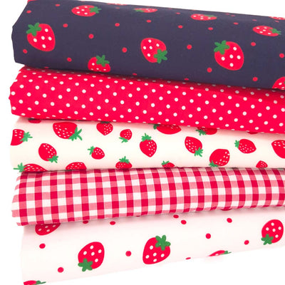 A fat quarter bundle of strawberries, spots and gingham on polycotton fabric
