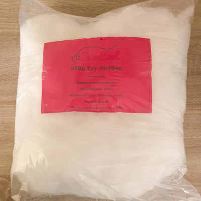Bag of toy stuffing with a red label on a wooden surface