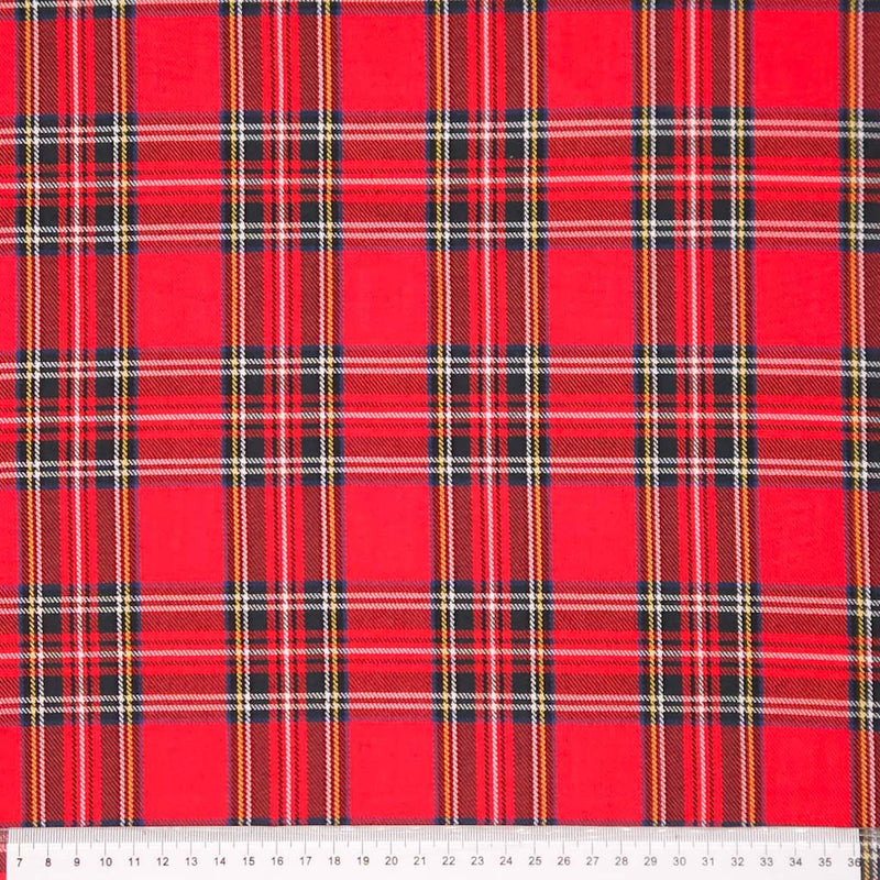 Red tartan fabric pattern on polyviscose fabric with a cm ruler
