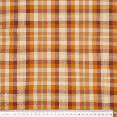 A caramel coloured tartan polyviscose fabric with a cm ruler