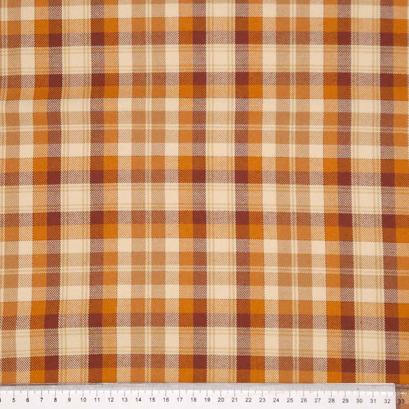 A caramel coloured tartan polyviscose fabric with a cm ruler