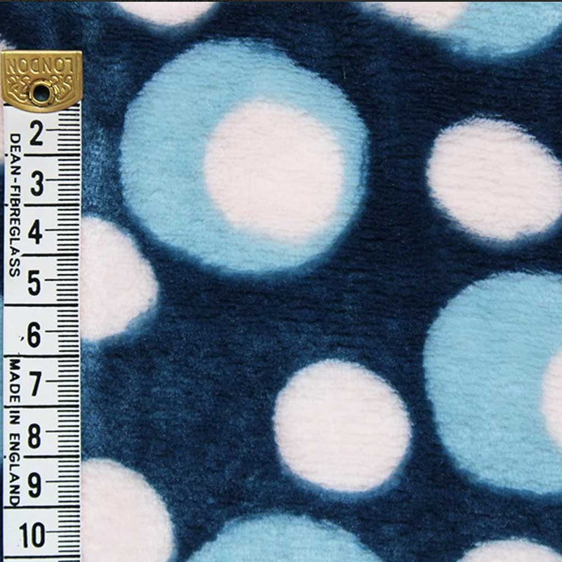 White and blue spots printed on a teal cuddle fleece with a cm ruler