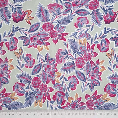Deep red leaves and florals printed on a sage green tencel fabric with a cm ruler