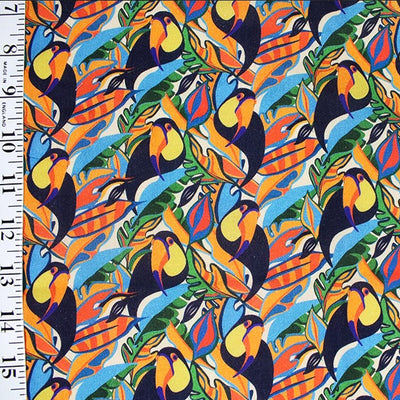 Toucans printed on colourful foliage. Cotton fabric design by Little Johnny with ruler