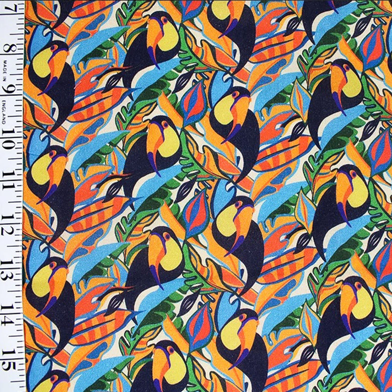 Toucans printed on colourful foliage. Cotton fabric design by Little Johnny with ruler