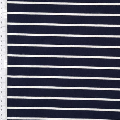 A navy ribbed viscose jersey fabric with white stripes with a cm ruler