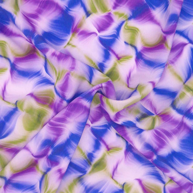 A liquid ink design in purple and green, printed on a viscose dressmaking fabric in a swirl