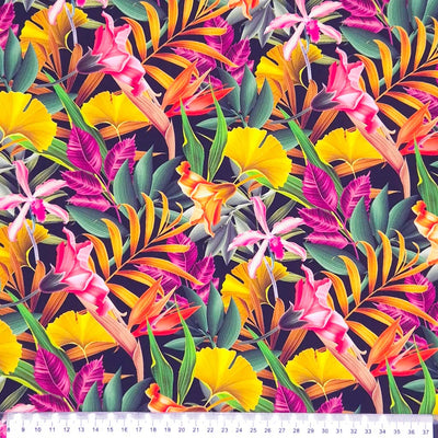 Colour-filled floral viscose fabric featuring beautiful flowers and leaves in summer shades of yellow, orange, pink and green, on a contrasting black background with a cm ruler