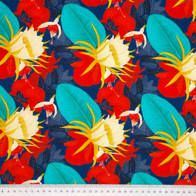 Tropical florals in reds and turquoise on a navy background printed on a viscose fabric with a cm ruler