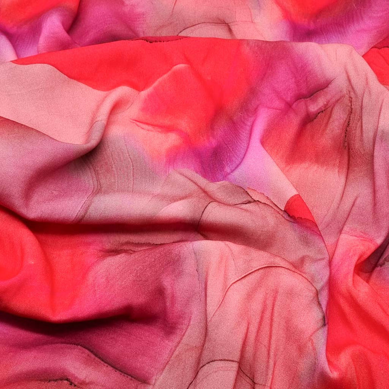 Viscose fabric printed with a flowing ink design in pinks