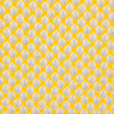 Leaves printed on a yellow viscose dressmaking fabric