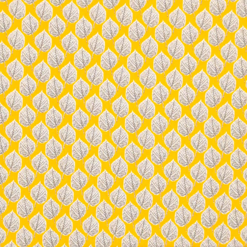 Leaves printed on a yellow viscose dressmaking fabric