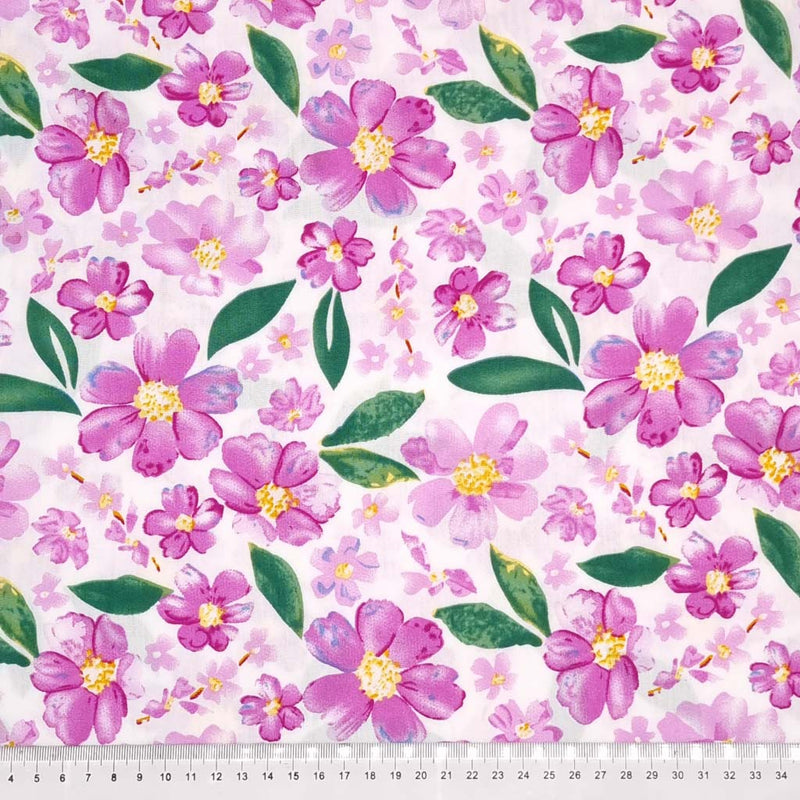 Pretty lilac coloured flowers are printed on an ivory woven viscose fabric with a cm ruler