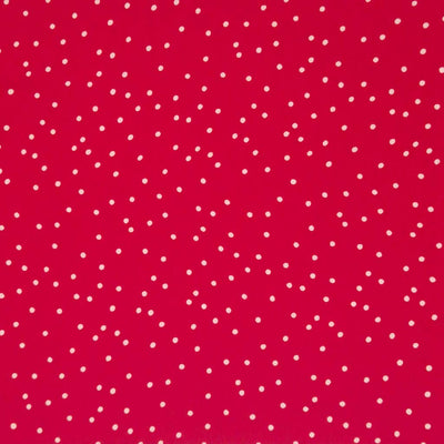 Small scattered white spots printed on red viscose fabric