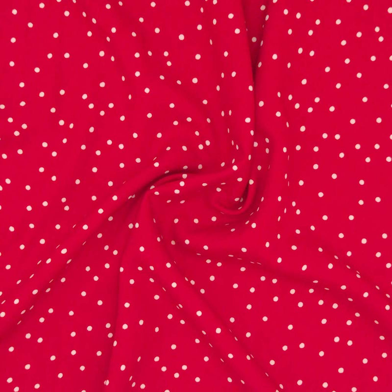 Small scattered white spots printed on red viscose fabric