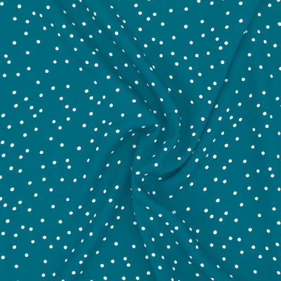 Small scattered white spots printed on teal viscose fabric