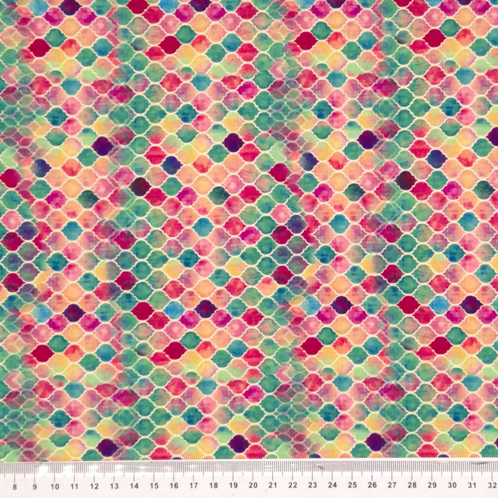 Pink, turquoise, blue and purple domes fixed in a tight pattern printed on a viscose jersey fabric. With ruler