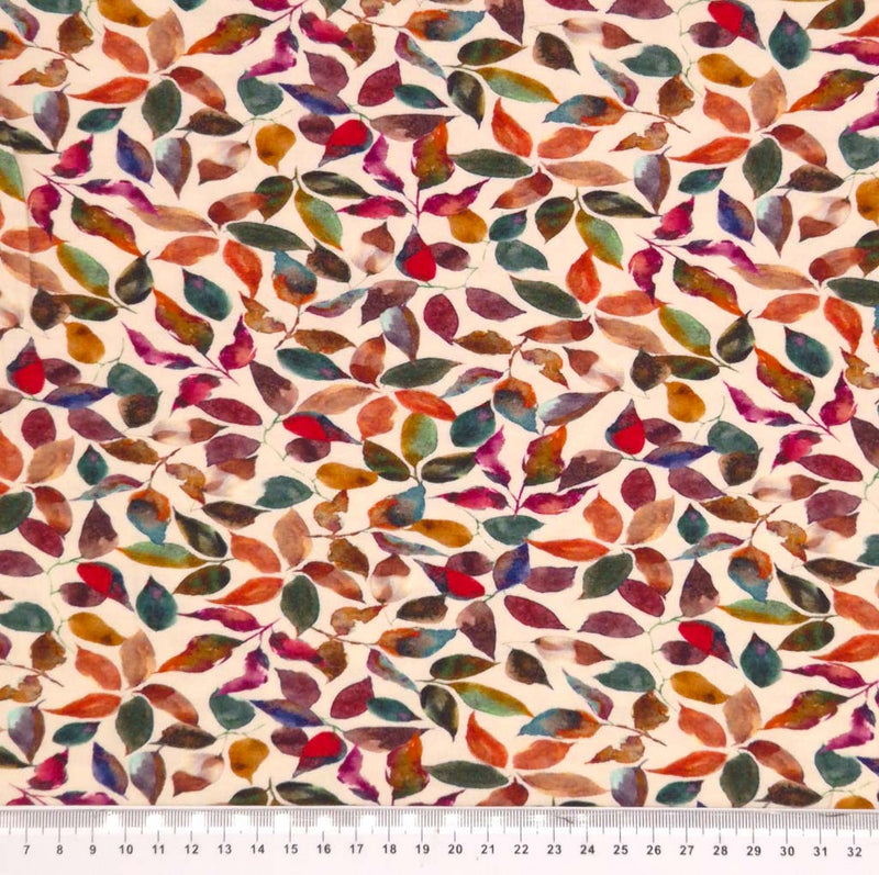 Autumnal leaves printed on a beige viscose jersey fabric with a cm ruler