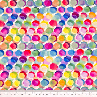 Watercolour painted colourful spots printed on a viscose jersey fabric with a cm ruler