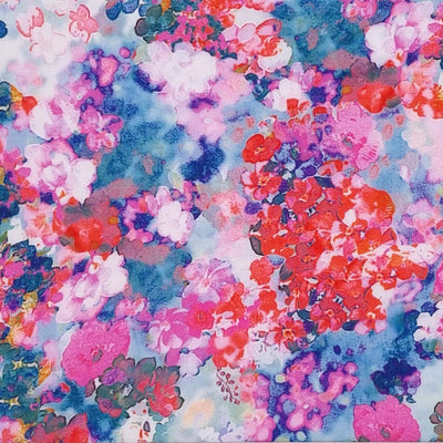 Flowers in reds and pinks are printed on a blue viscose fabric