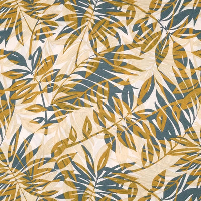 Teal and golden tropical leaves are printed on an ivory viscose dressmaking fabric