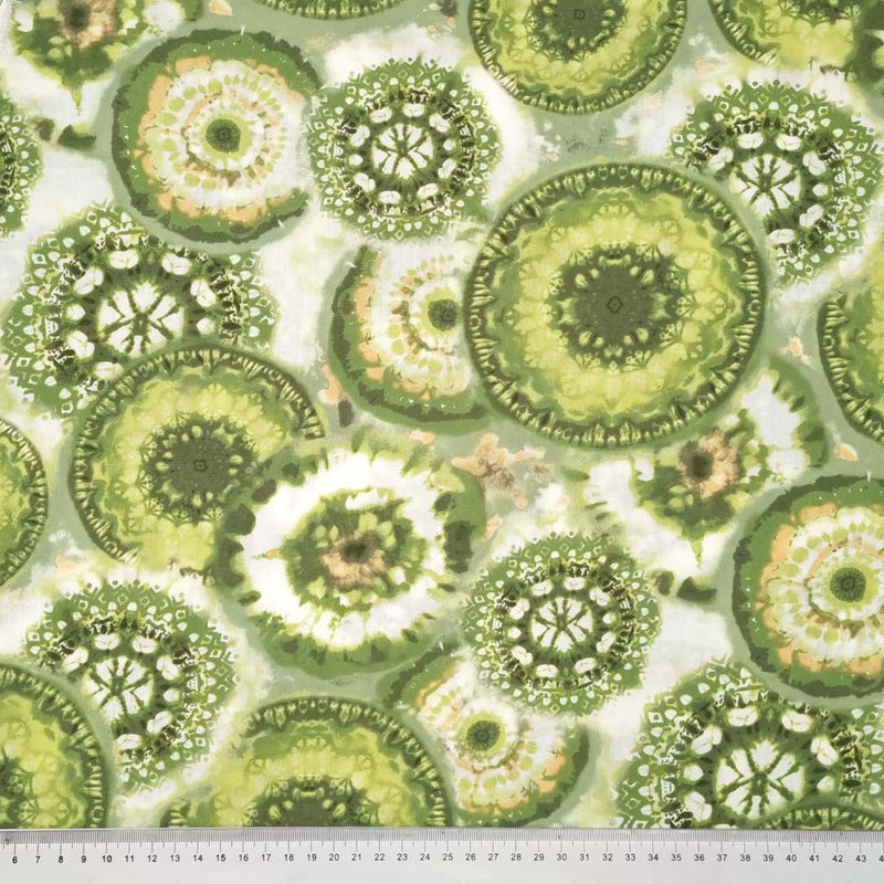 Lime green circles are printed on a rayon cotton mix fabric with a cm ruler