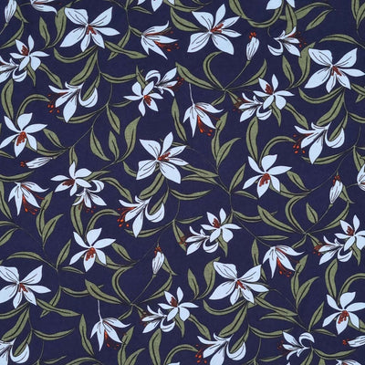 A pale blue lily flower is printed on a navy viscose fabric
