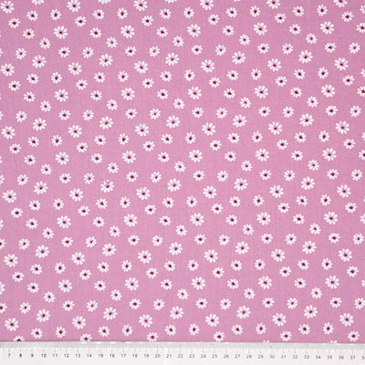 Vintage daisies printed on a dusky pink washed cotton fabric with a cm ruler