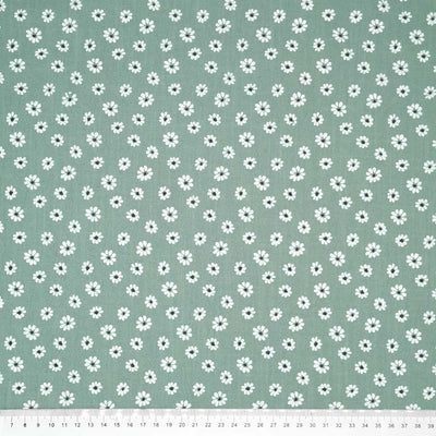 Vintage daisies printed on a sage green washed cotton fabric with a cm ruler