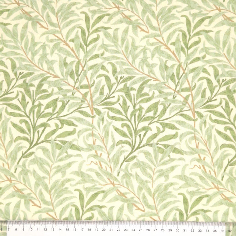 William Morris willow bough design in sage green, printed on a cotton fabric with a cm ruler