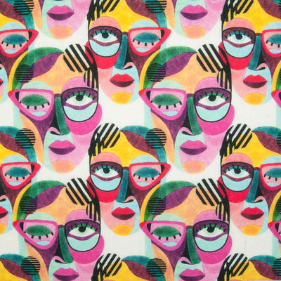 Abstract face paintings in vibrant pinks and greens are printed on a 100% cotton fabric by Little Johnny