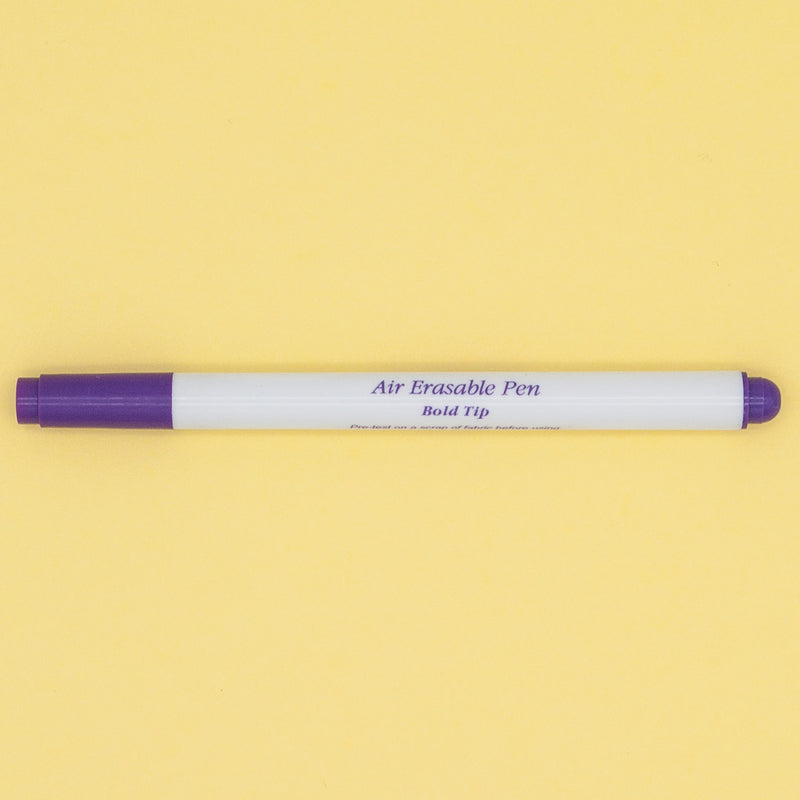 A purple and white bold tipped air drying fabric marker
