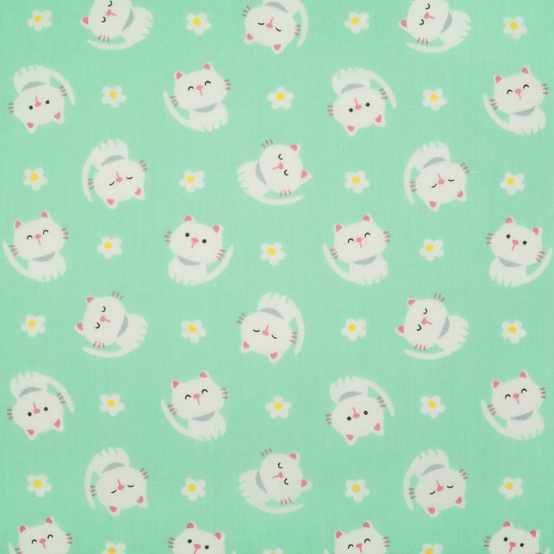 White cats with little daisies are printed on a mint polycotton fabric