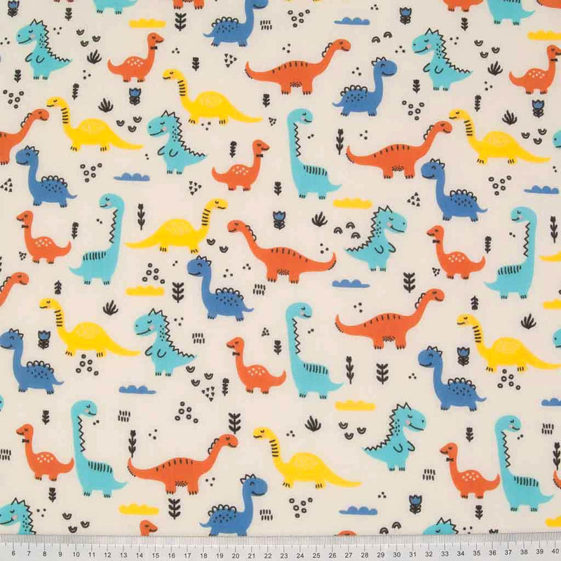 Yellow, turquoise, orange and blue happy dinosaurs printed on a cream polycotton fabric with a cm ruler at the bottom
