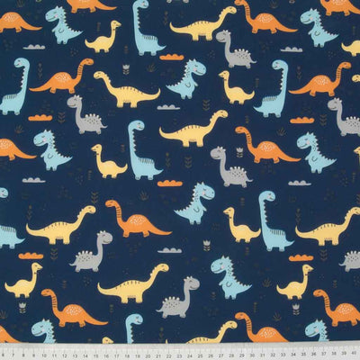 Yellow, blue and grey happy dinosaurs printed on a navy polycotton fabric with a cm ruler at the bottom