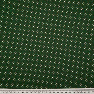 2mm gold lacquer pin spots are printed on a bottle green cotton christmas fabric with a cm ruler at the bottom