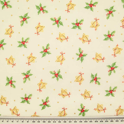 Springs of green holly with red berries and rustic wicker stars are printed on an ivory cotton fabric with a ruler at the bottom