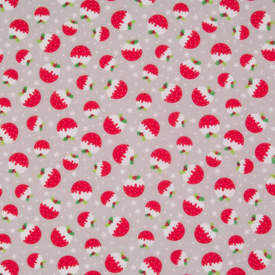 Ditsy red christmas puddings are printed on a silver christmas polycotton fabric