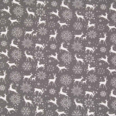 White reindeer and snowflakes are printed on a grey christmas polycotton fabric