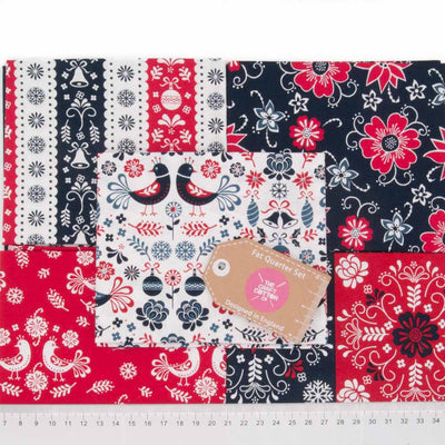 Five cotton fat quarters in navy, red and white colours are printed with scandinavian style festive designs with a cm ruler at the bottom